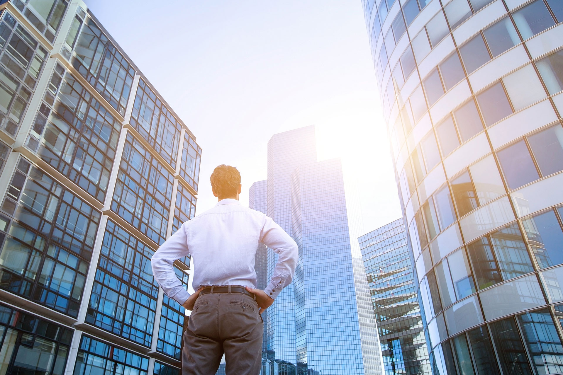 image of man standing among buildings